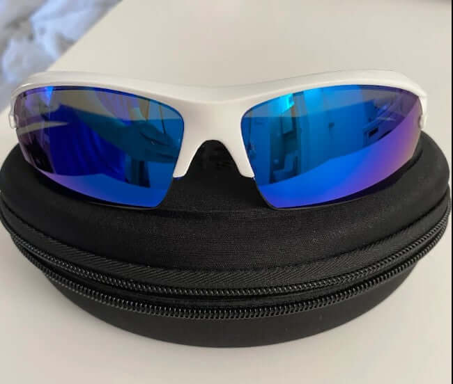 Prescription glasses with sunglass tint and mirror coating fitted for customer's own oakley frames.